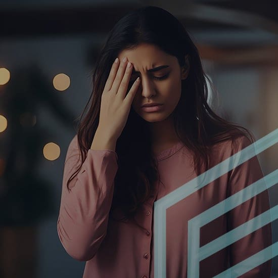 A woman with long dark hair, wearing a pink top, stands with a distressed expression, her eyes closed and her right hand placed on her forehead. In the background, there are blurry lights. Geometric shapes are visible in the foreground.