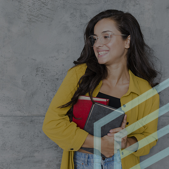 A woman wearing glasses, a yellow shirt, and blue jeans is smiling and looking to her left while holding two books, one red and one black. The background is a textured, gray concrete wall. Transparent lines in a light blue color overlay the image on the right side.