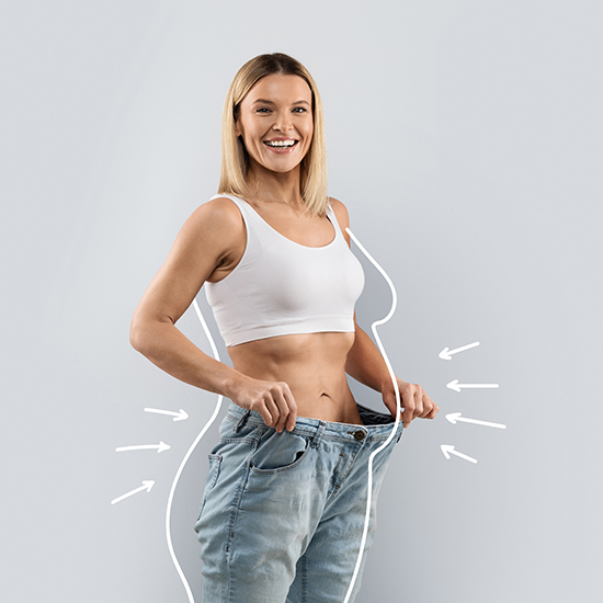 A smiling woman in a white tank top and blue jeans holds the waistband of her loose-fitting jeans, showing excess weight loss. White arrows and outlines on the image highlight her slimmer figure.